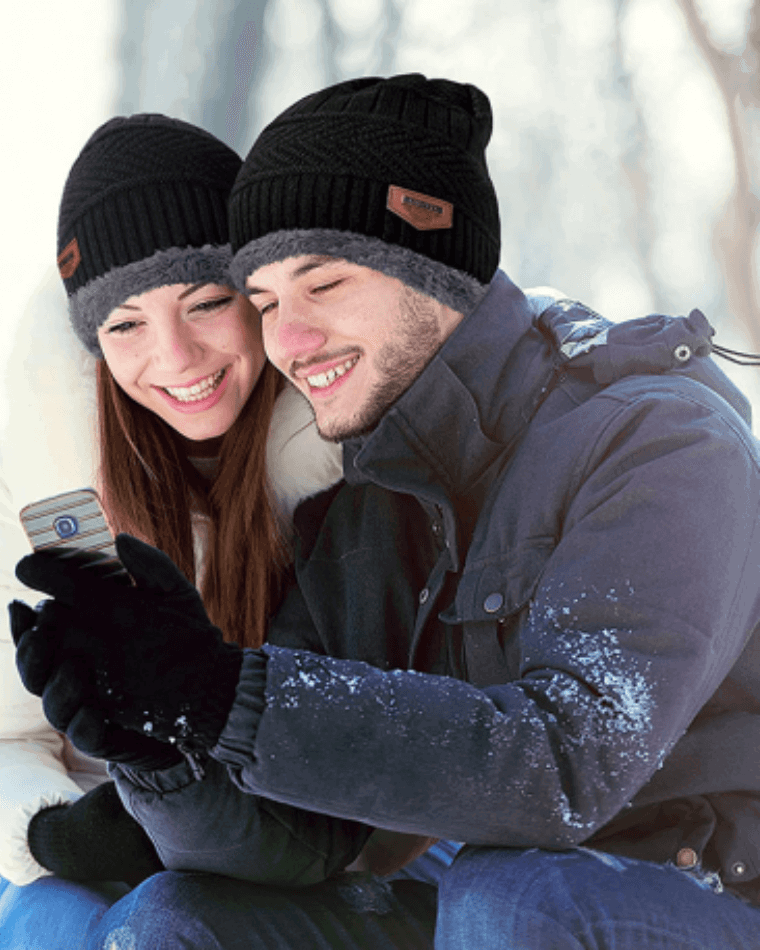 happy-couple-wearing-winter-caps-and-mufflers