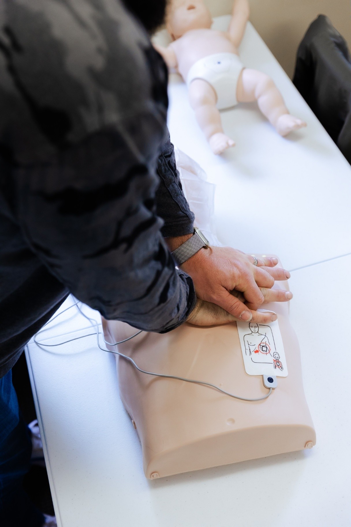 CPR and AED being used on manikin