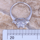 Julia: Spectacular white rectangular simulated diamonds supported with 2 charming triangular ones - rings well suited for propo