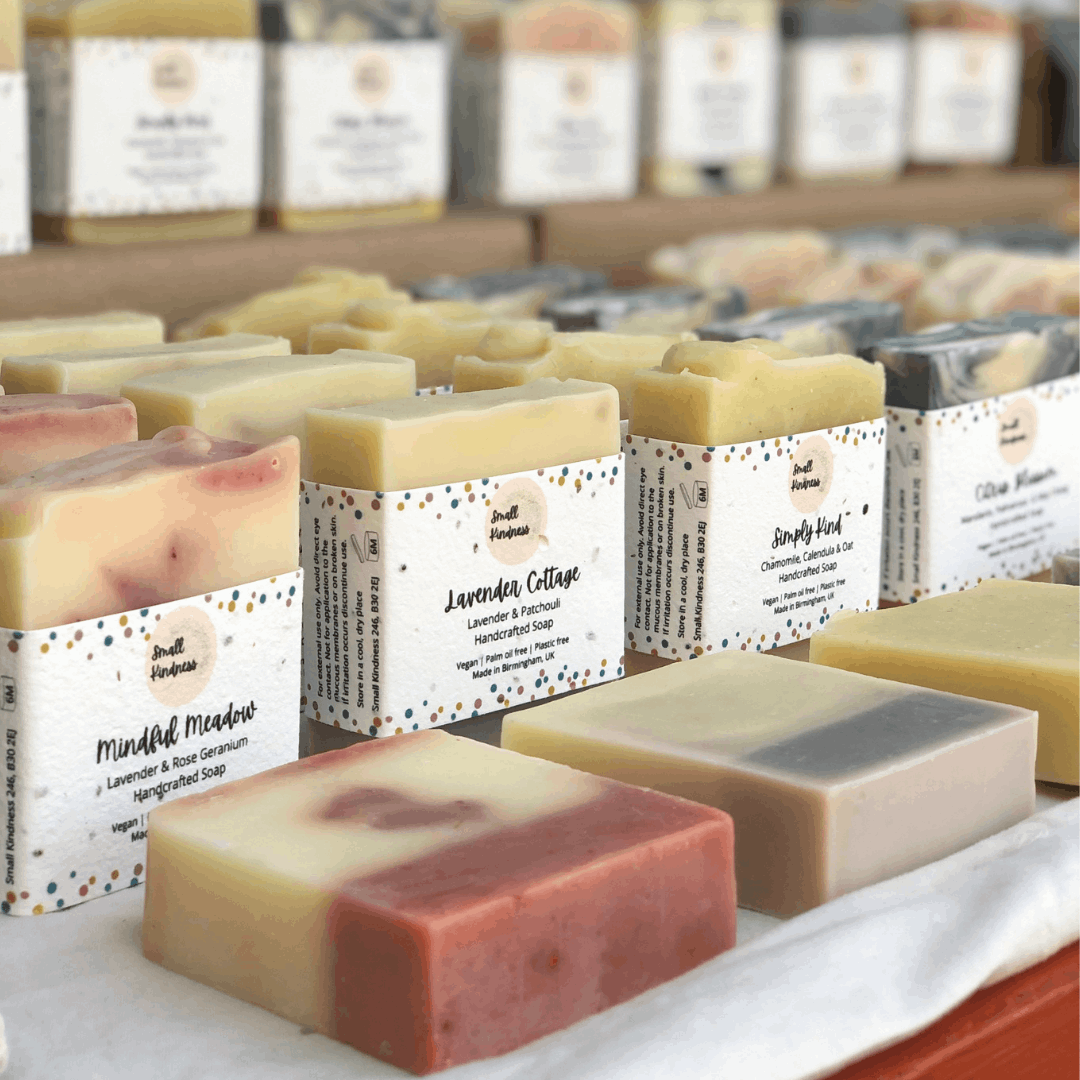 Small Kindness vegan soaps in rows ready to buy at a market